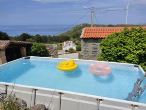 two frisbees sitting on top of a swimming pool at A Vixía do Roncudo in Corme-Puerto