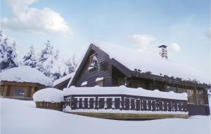 a building covered in snow with snow on the roof at Hytte Nr 4-156 in Frafjord +7 photos