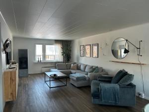 a living room with a couch and a table at Familjevänligt hus i Kiruna in Kiruna