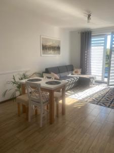 a living room with a table and a couch at APARTAMENT MARTA in Zamość