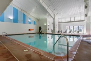 a large swimming pool in a building at Dog-Friendly A-Frame with Firepit and Fall Foliage in Hedgesville