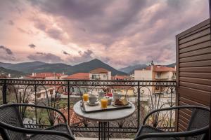 a table with a tray of food on top of a balcony at Marianna's Home Accommodation in Karpenisi