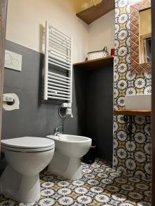 a bathroom with a toilet and a sink at Il Girasole Storico in Pitigliano