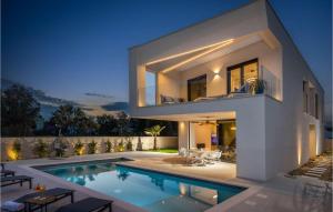 a house with a swimming pool in front of it at Villa Meta in Petrcane