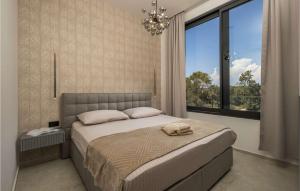 a bedroom with a large bed and a large window at Villa Meta in Petrcane