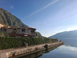 a house on the side of a body of water at Apartment Marija in Risan
