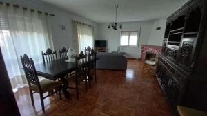 a living room with a table and a couch at Casa do Tonito in Carregal do Sal