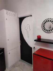 a room with a black door and a red cabinet at Ονειροπαγίδα in Veria