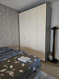 a bedroom with a bed and a large white cabinet at Casa GopNa in Udine +1 photo