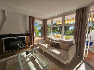 a living room with a couch and a fireplace at Casa Jardin- Lovely 2bed 2bath flat Calahonda - 475m to the beach in Sitio de Calahonda
