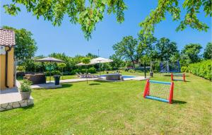 a playground with a seesaw in a park at Lovely Home In Vinjani Gornji in Nenadići