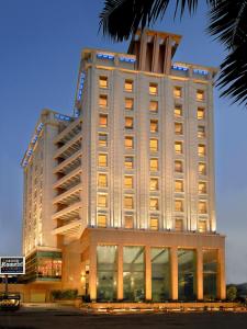 a large white building with lights on top of it at Lemon Tree Premier, Malad, Mumbai in Mumbai