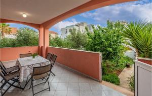 a patio with a table and chairs on a balcony at Two-Bedroom Apartment In Vir in Vir