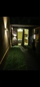 a night view of a house with a grass yard at Cálida CASA para GRUPOS en Ciudad del Este a Pasos del Estadio 3 de Febrero in Ciudad del Este