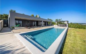 a swimming pool in the backyard of a house at Villa Bartolo in Labin