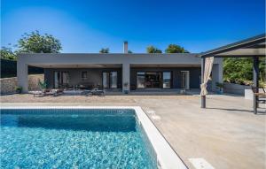 a swimming pool in front of a house at Villa Bartolo in Labin