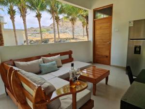 a living room with a couch and a table at Casa Playa "Alicia Micaela" in Zorritos