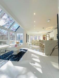 a living room with a kitchen and a dining room at Mountain Vista Luxury Retreat! in Pound Ridge
