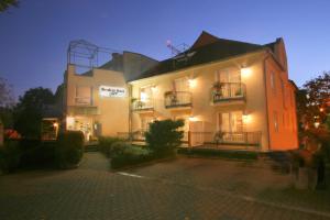 a large white building with lights on it at Residenz Hotel Giessen in Gießen
