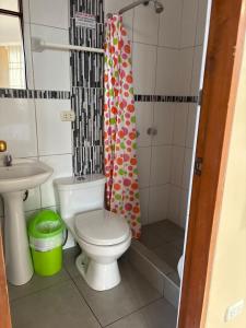 a bathroom with a toilet and a sink and a shower at Hospedaje CRUZ Oxapampa in Oxapampa +22 photos