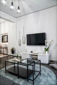 a living room with a tv and a coffee table at Luxury Apartment near Acropolis in the Heart of Athens in Athens