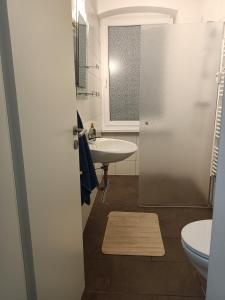 a bathroom with a sink and a toilet at Komfortable Wohnung in Kassel