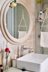 a bathroom with a white sink and a mirror at Happy Nest Tuscany in Castiglion Fiorentino +43 photos