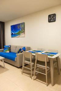 a living room with a couch and a table and chairs at Vera Playa apartment in Vera