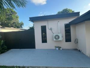 a house with a clock on the side of it at MG Realty Luxury Stay in Miami