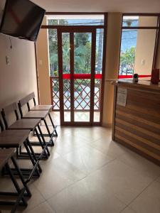 a waiting area with tables and chairs in a restaurant at Hospedaje CRUZ Oxapampa in Oxapampa