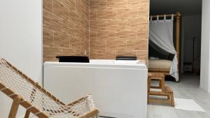 a room with a white counter and a bedroom at Bali Paradisiaque in Roubaix