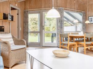 a living room with a table and chairs at 4 star holiday home in Nysted in Nysted