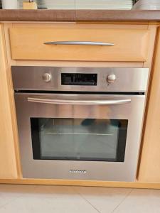 a stainless steel oven in a cabinet in a kitchen at Renewed Spacious 35m2 Studio in Paris in Paris