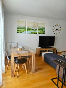 a living room with a table and a tv at Renewed Spacious 35m2 Studio in Paris in Paris