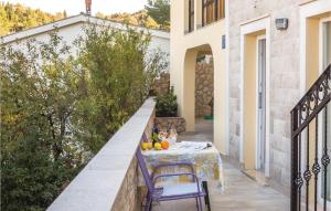 a table and chairs on a balcony of a house at Amazing Studio In Blace With Wifi in Ploča