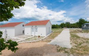 a white house with a red roof at Nice Home In Zavojane With Kitchen in Zavojane +17 photos