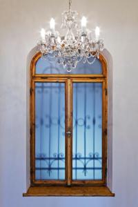 a chandelier and a window in a room at Apartment Al Centro in Olomouc