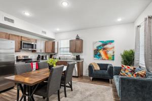 a kitchen and living room with a table and chairs at 15 Bedrooms in the Heart of NOLA in New Orleans