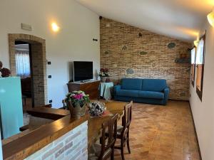 a living room with a blue couch and a table at Casa vacanze Pierangela in Susegana