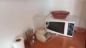 a blender sitting on a table next to a microwave at don federico tome in Tomé