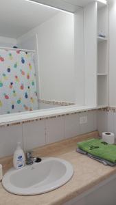 a bathroom counter with a sink and a mirror at don federico tome in Tomé +19 photos