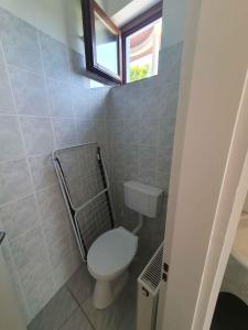 a small bathroom with a toilet and a window at Apartment in Zamardi - Balaton 53129 in Zamárdi +8 photos