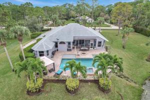 an aerial view of a house with a swimming pool at Why Is Everyone Obsessed With This House in Loxahatchee
