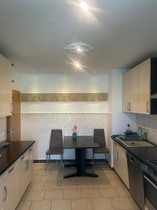 a kitchen with a table and two chairs in it at Pension Sonnenschein in Betzdorf