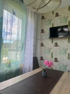 a dining room with a table and a wall with flowers at Pension Sonnenschein in Betzdorf