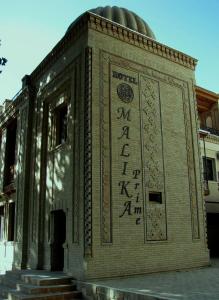 a building with writing on the side of it at Malika Prime Hotel in Samarkand