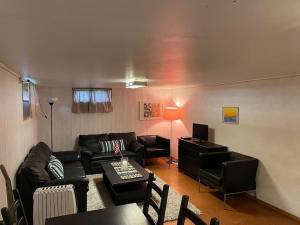 a living room with a couch and a table at Independent Apartment in Sandnes in Sandnes