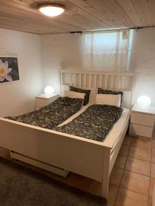 a bedroom with a large white bed with two lamps at Independent Apartment in Sandnes in Sandnes