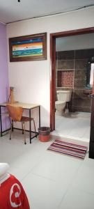 a bathroom with a sink and a toilet and a table at Gacelita Cozumel in Cozumel