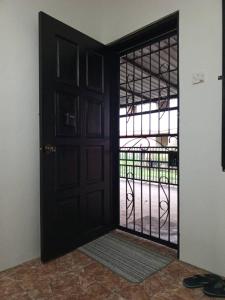 an open door with a view of a courtyard at Homestay Townvilla Sibujaya Unit 6 in Sibu